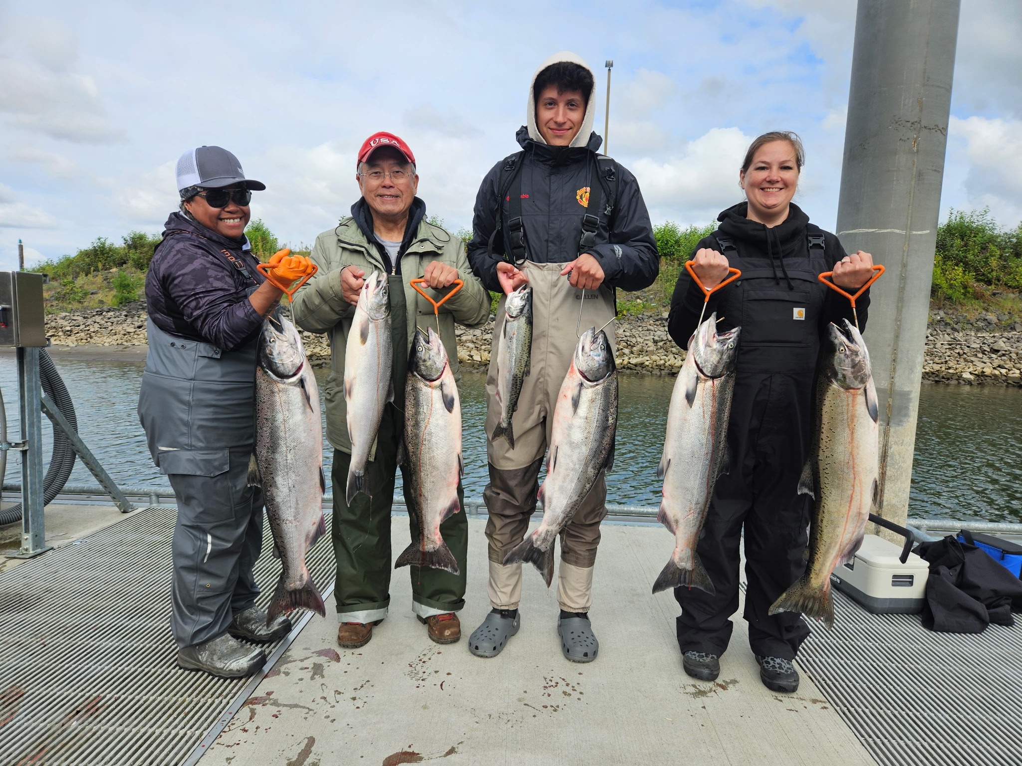A group of four anglers at the boat ramp with a haul of Columbia River Chinook salmon caught on a guided trip with Tony O Guided Adventure.